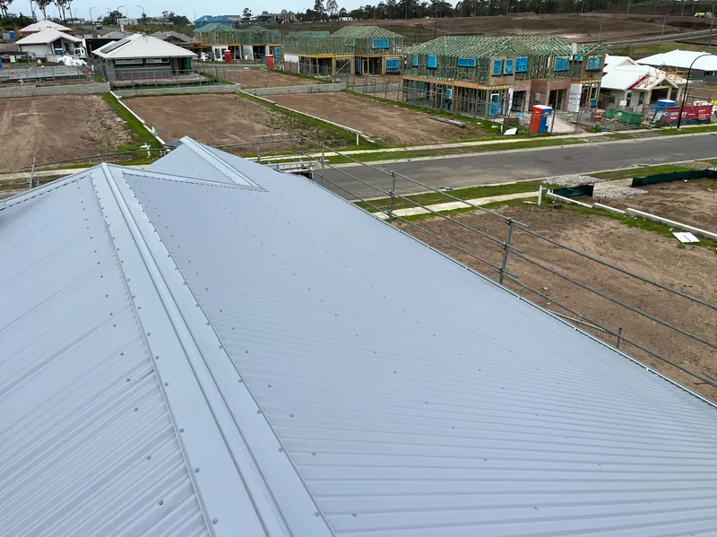 Light-coloured corrugated roof on a home in a new estate