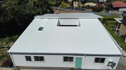 Off-white Surfmist roof with skylights by Auzsheet Roofing on a Charlestown home