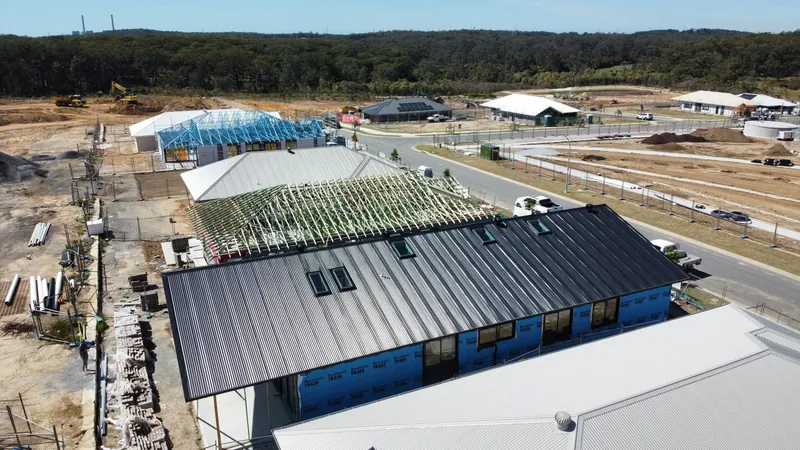 Dark roof on the Cooranbong job, with bushland behind